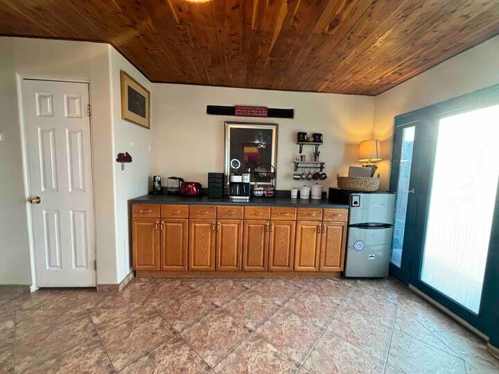 A kitchen with wooden cabinets and tile floors.