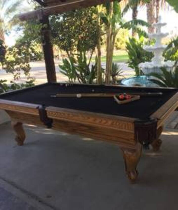 A pool table with a black cloth on it