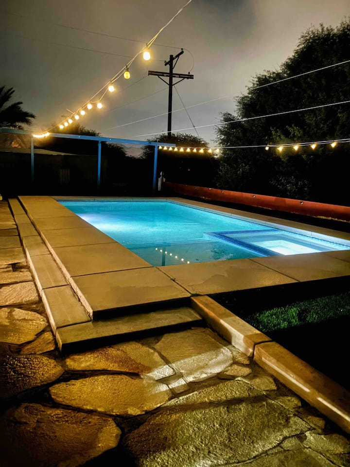 A pool with lights on the side of it