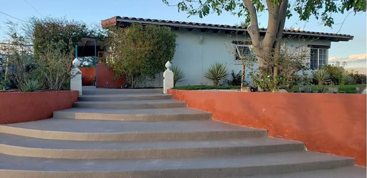 A house with stairs leading to the front door.