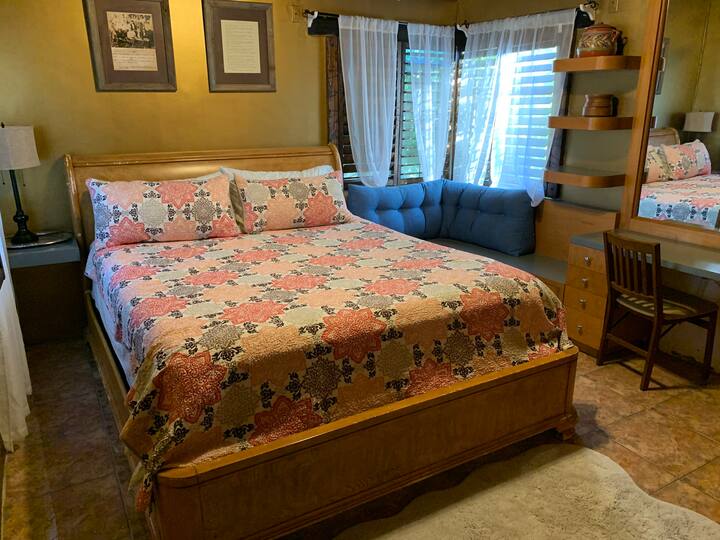 A bed room with a large bed and a window