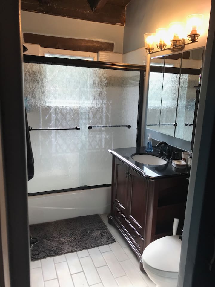 A bathroom with a sink, toilet and shower.
