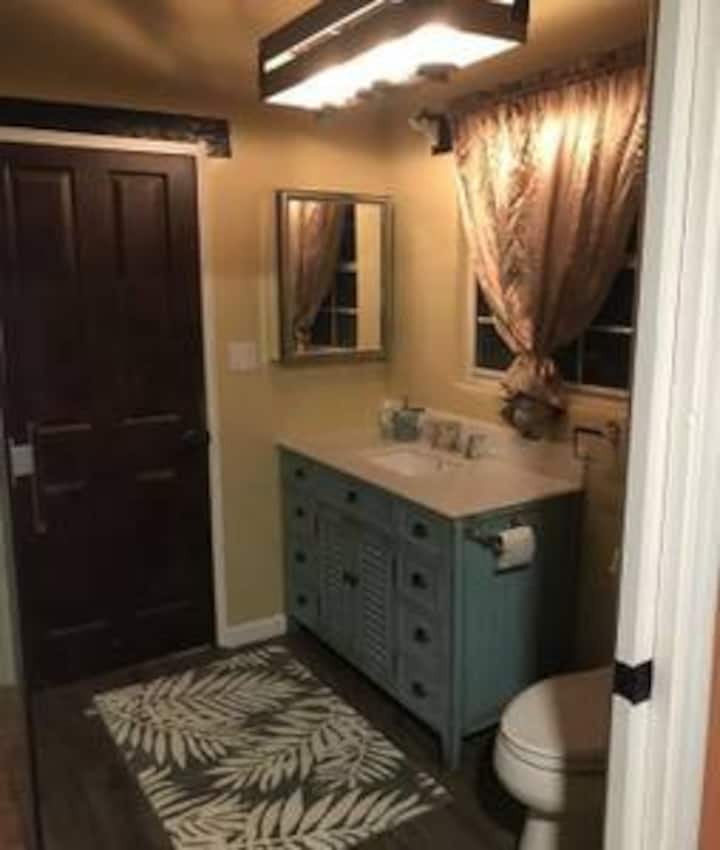 A bathroom with a sink, mirror and toilet.