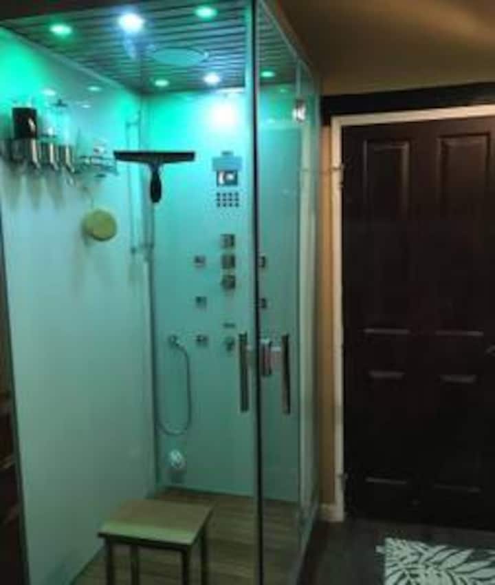 A bathroom with a shower and tiled floors.