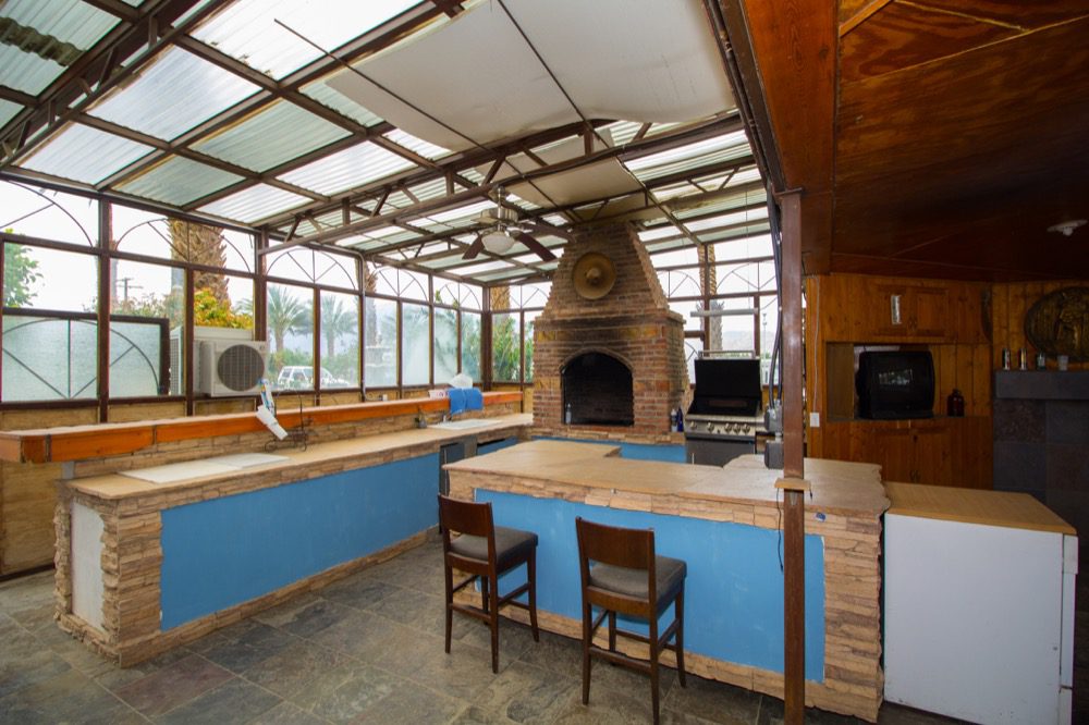 A kitchen with a fireplace and a blue wall.