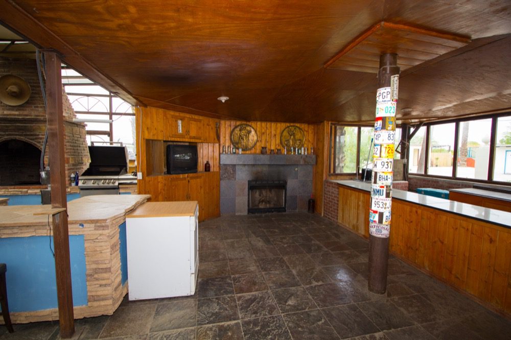 A kitchen with a stove, oven and fireplace.