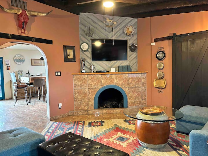 A living room with a fireplace and a television.