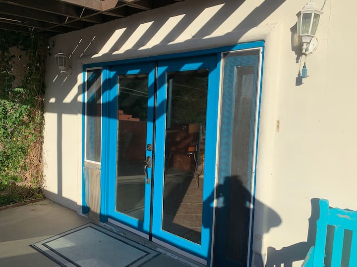 A blue door is shown on the outside of a building.