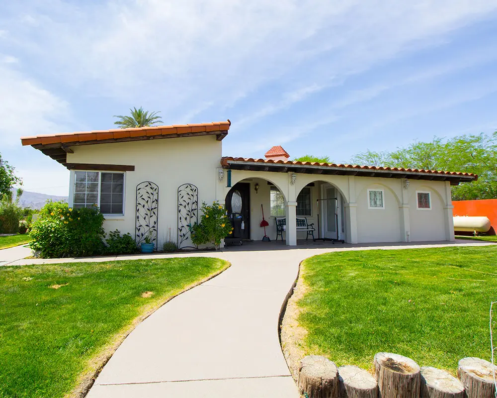 A house with a walkway leading to the front door.